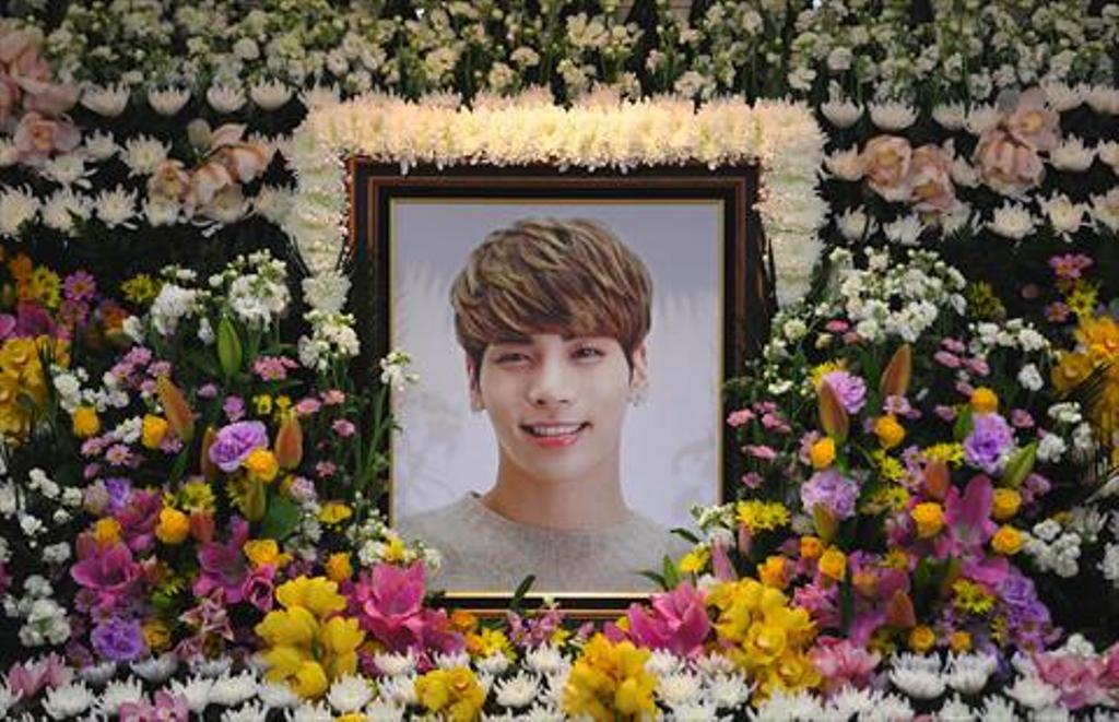The portrait of Kim Jong-Hyun, a 27-year-old lead singer of the massively popular K-pop boyband SHINee, is seen on a mourning altar at a hospital in Seoul on December 19, 2017.  / AFP / pool / CHOI Hyuk