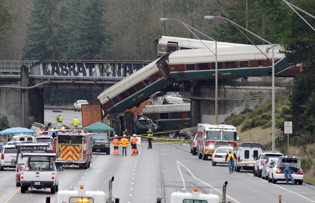 Rescue personnel and equipment are seen at the scene where an Amtrak passenger train derailed on a bridge over interstate highway I-5 in DuPont, Washington, U.S. December 18, 2017. REUTERS/Steve Dipaola.