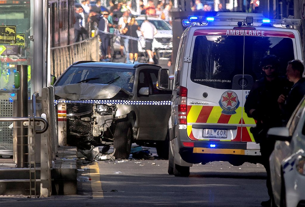 Australian police stand near a crashed vehicle after they arrested the driver of a vehicle that had ploughed into pedestrians at a crowded intersection near the Flinders Street train station in central Melbourne, Australia December 21, 2017. REUTERS/Luis 