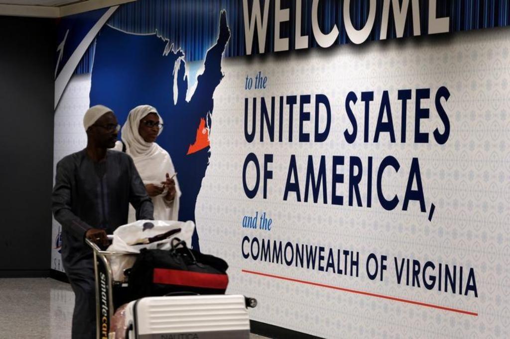 A file photo of International passengers arriving at Washington Dulles International Airport after the US Supreme Court granted parts of the Trump administration's emergency request to put its travel ban into effect later in the week pending further judic