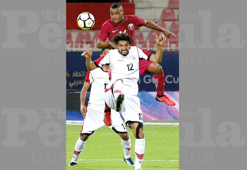 Qatar’s Assim Madibo (top) vies for the ball during the opening match of the Gulf Cup on Saturday.