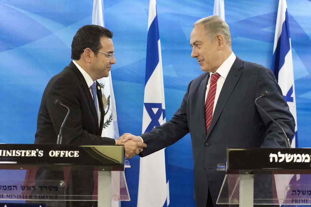 (FILES) This file picture taken on November 28, 2016 shows Guatemalan President Jimmy Morales (L) and Israeli Prime Minister Benjamin Netanyahu (R) shaking hands during a joint press conference after signing bilateral agreements at the Prime Minister's Of