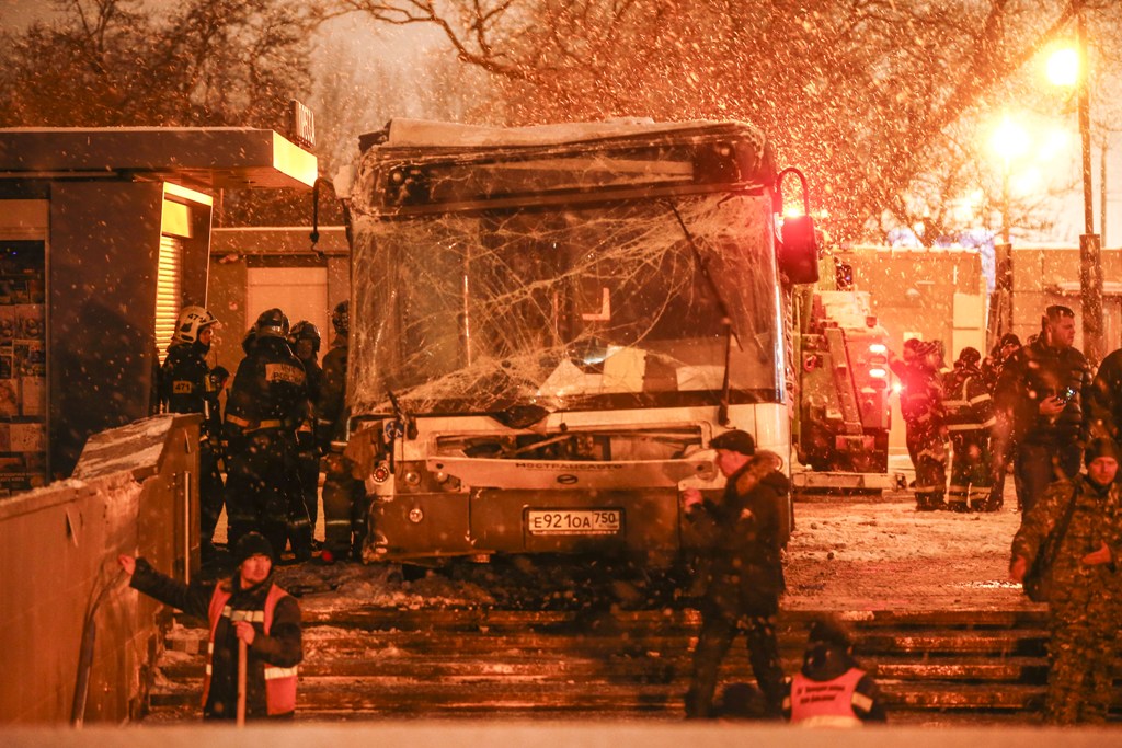 Russian officials inspect the scene after a bus plowed into a Moscow subway entrance, leaving at least five people dead and 15 injured, in Moscow, Russia on December 25, 2017. Sefa Karacan - Anadolu