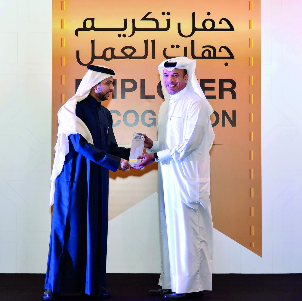 Ali Hamad Al Mesaifri (right), Chief of Human Resources and General Services at QIIB, receives a memento from Dr Hassan Rashid Al Derham, President, Qatar University.