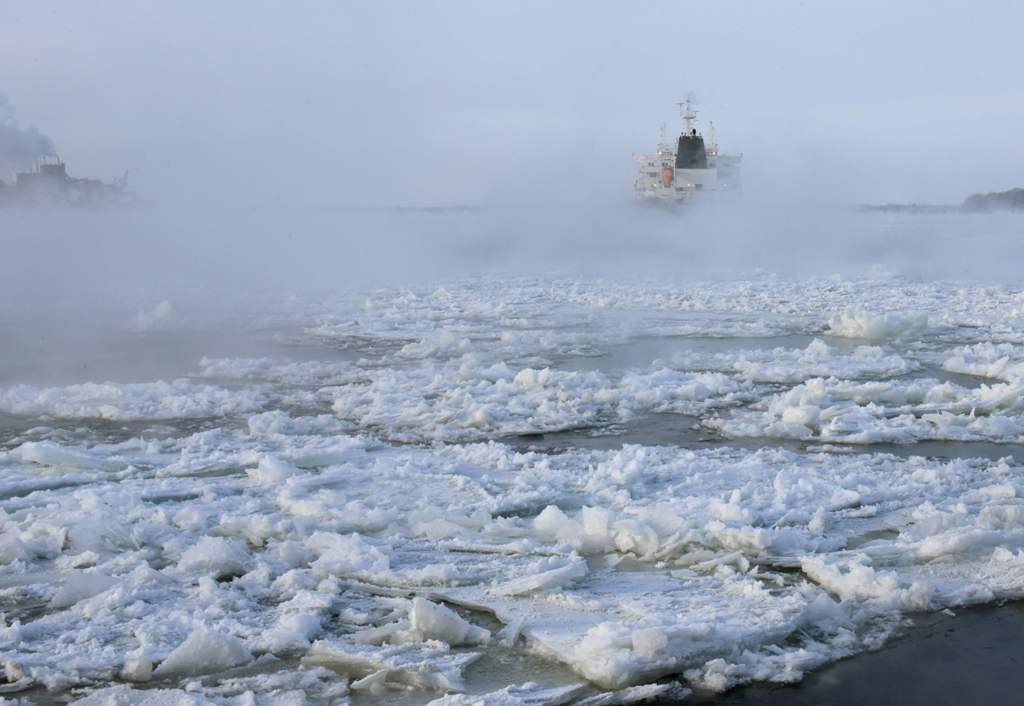 Cargo ships make their way down the ice-covered Saint Lawrence River December 28, 2017 at the Sorel-Tracy Ferry crossing in Sorel-Tracy, Quebec. / AFP / AFP PHOTO / Timothy A. CLARY