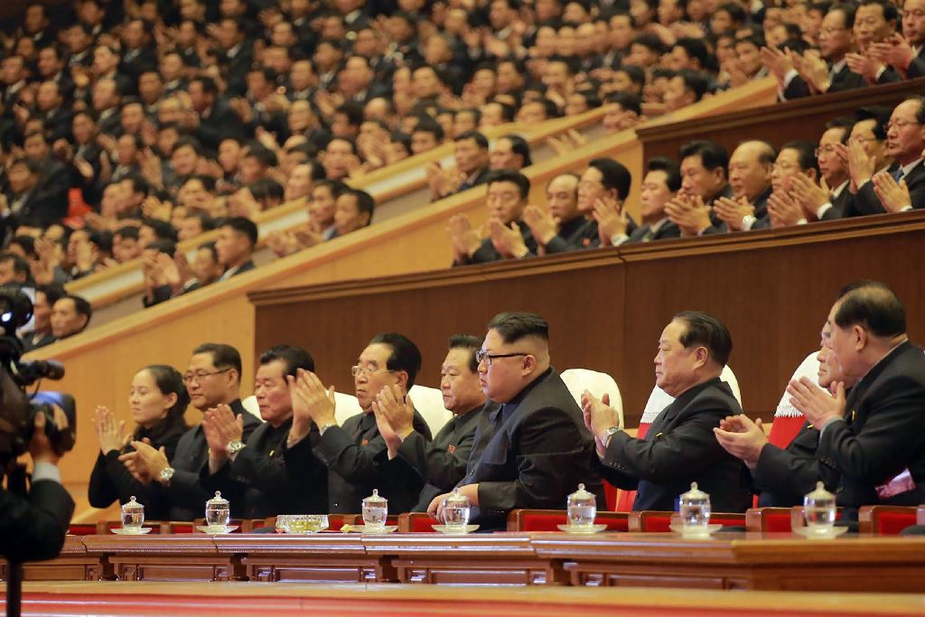This picture from North Korea's official Korean Central News Agency (KCNA) taken on December 29, 2017 and released on December 30, 2017 shows North Korean leader Kim Jong-Un (front C) attending an art performance of chorus and the Moranbong band with part