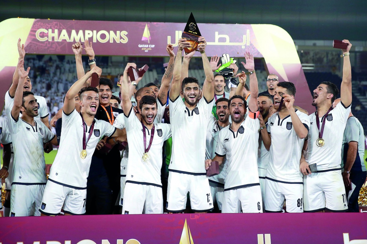 Al Sadd players lift Qatar Cup. 