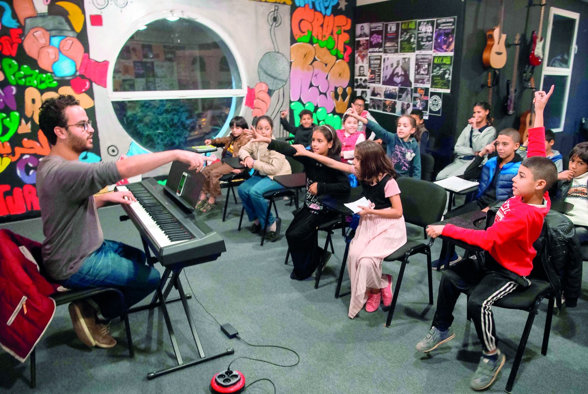 Local Moroccan children attend a music class at the Stars Cultural Centre in Casablanca's northeastern suburb of Sidi Moumen on November 24, 2017. Based in a white building next to a tramline and opposite a mosque, the Stars Cultural Centre regularly host