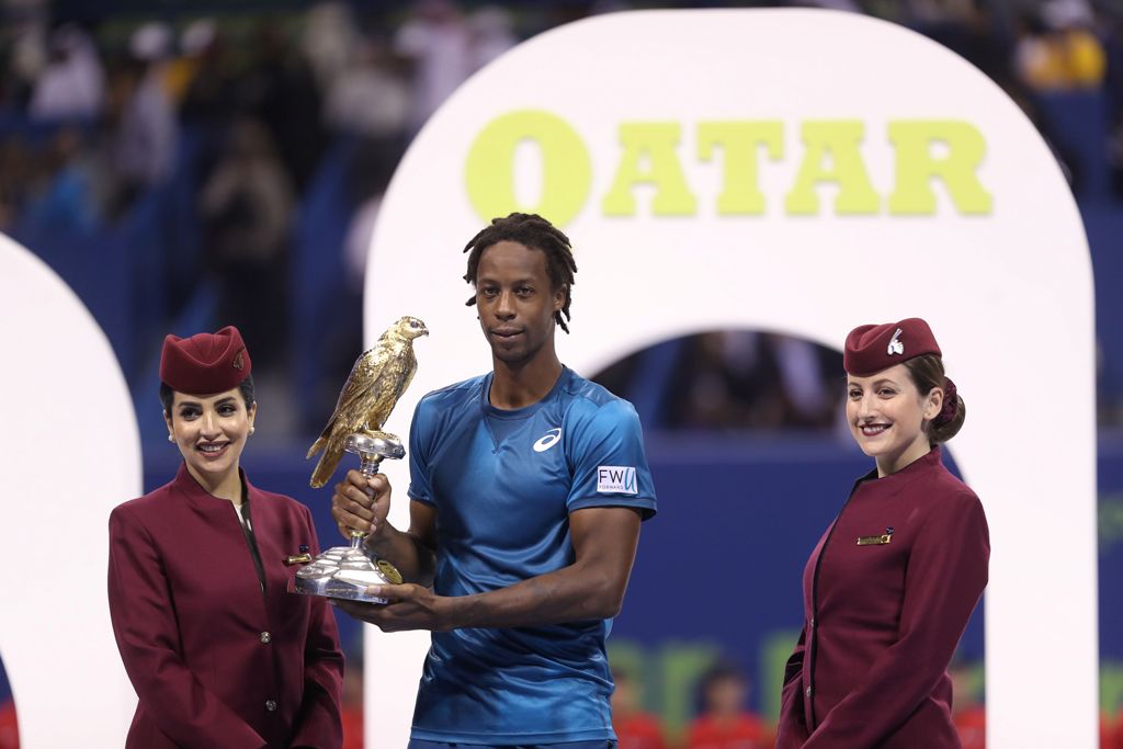 Gael Monfils of France holds the winner's trophy after winning against Russia's Andrey Rublev in the ATP Qatar Open tennis competition in Doha on January 6, 2018. Monfils won the Qatar Open final in straight sets, brushing aside Rublev in a one-sided fina