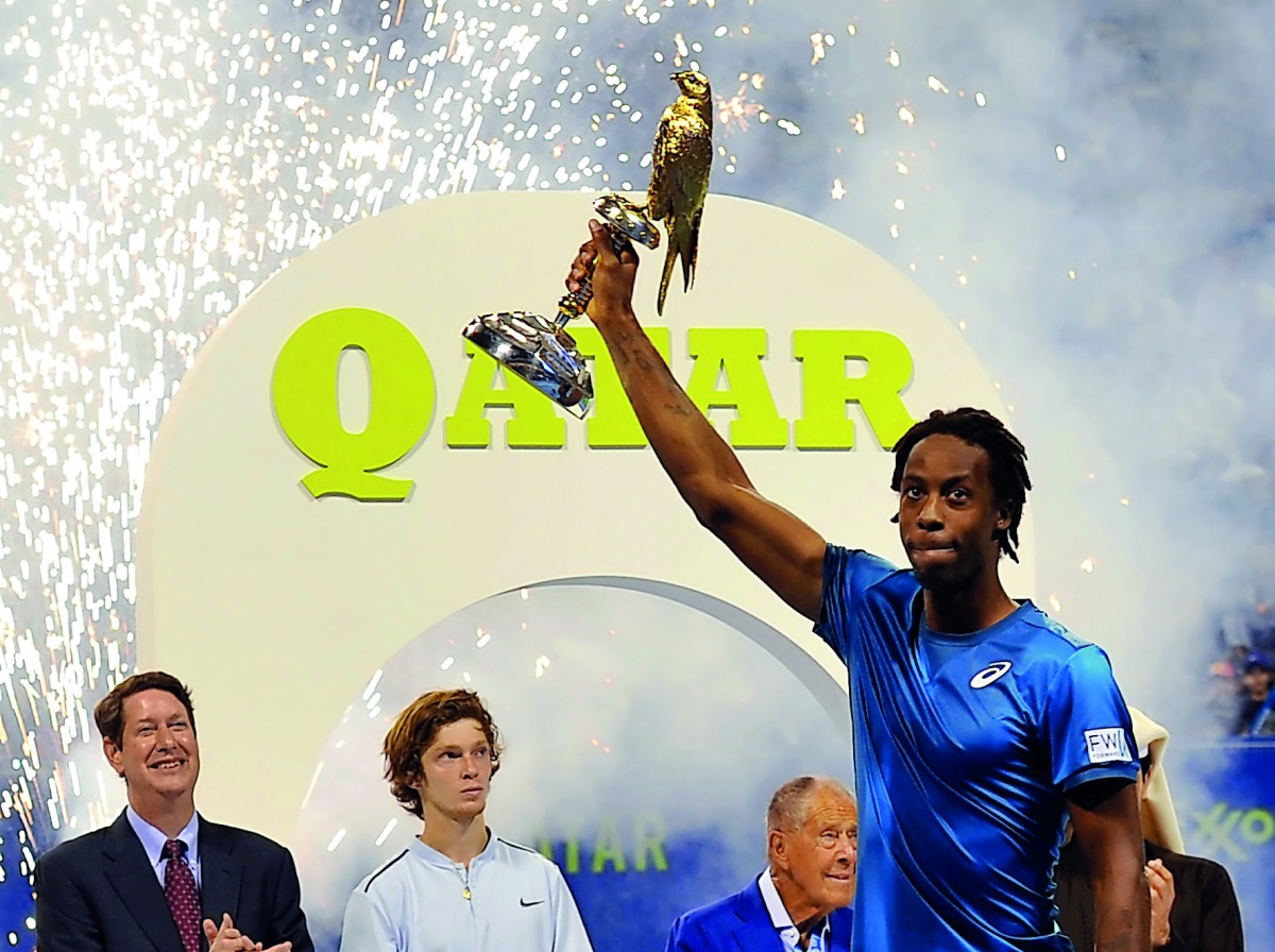 Qatar ExxonMobil Open 2018 champion Gaël Monfils celebrates with the trophy at the Khalifa International Tennis and Squash Complex in Doha yesterday. Picture by Kammutty VP / The Peninsula