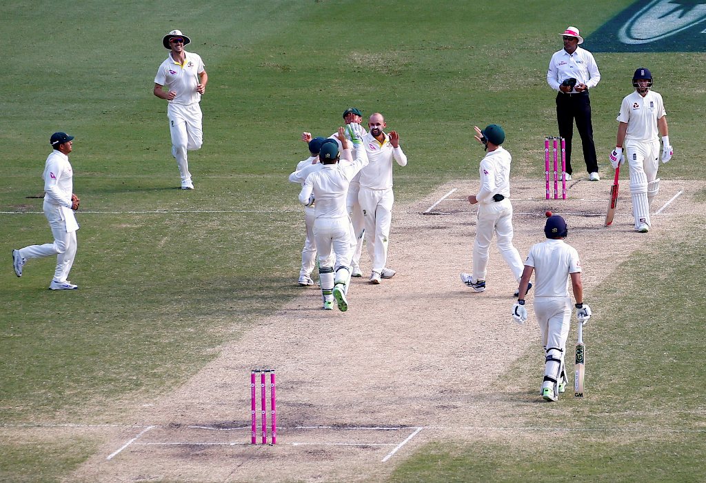 England's captain Joe Root reacts as Australia's Nathan Lyon celebrates with team mates dismissing Dawid Malan during the fourth day of the fifth Ashes cricket test match. (REUTERS/David Gray)