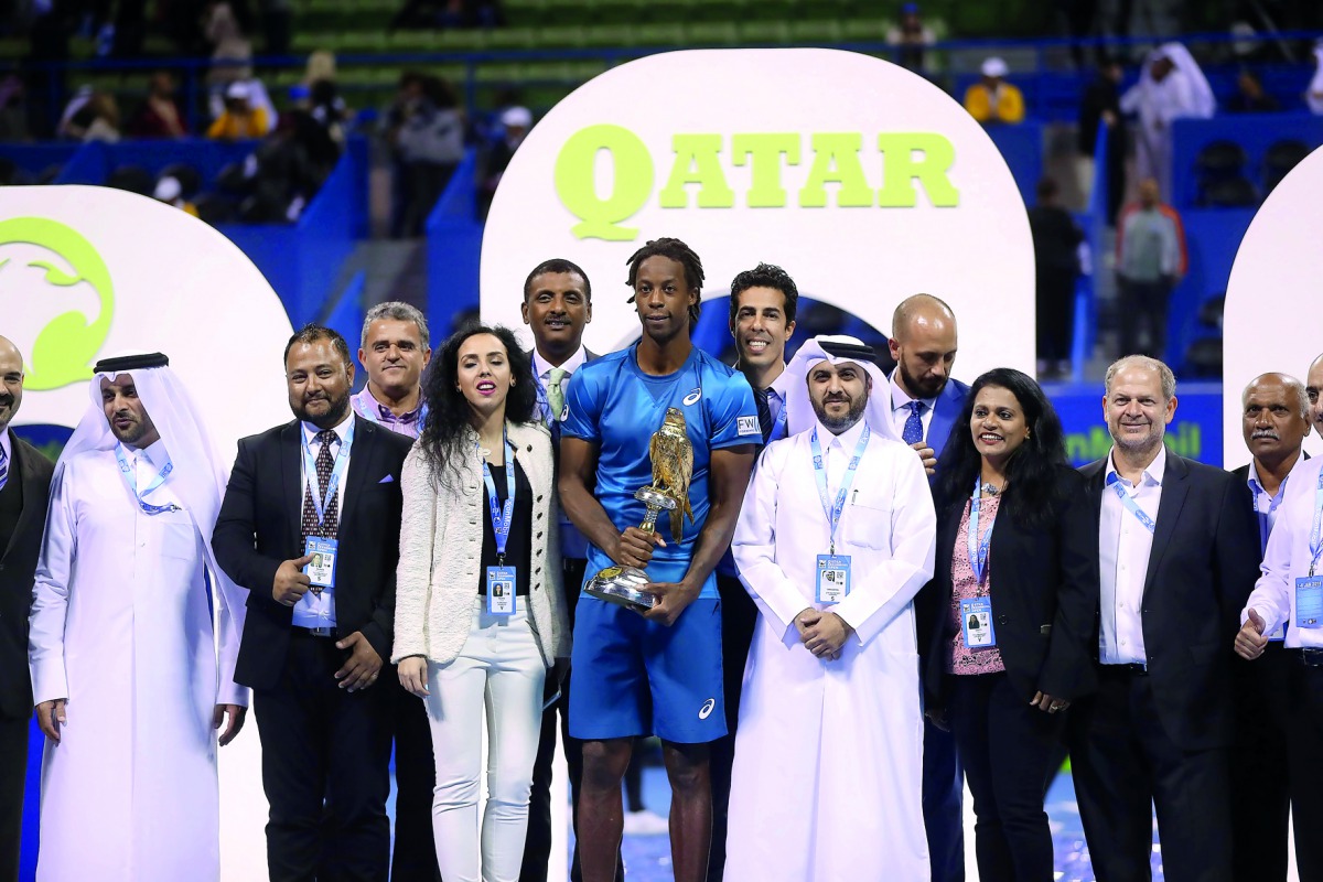Qatar ExxonMobil Open champion Gael Monfils of France is seen with Qatar Tennis Federation officials and members of the organizing committee following the final staged at Khalifa Tennis and Squash Complex in Doha on Saturday night. 