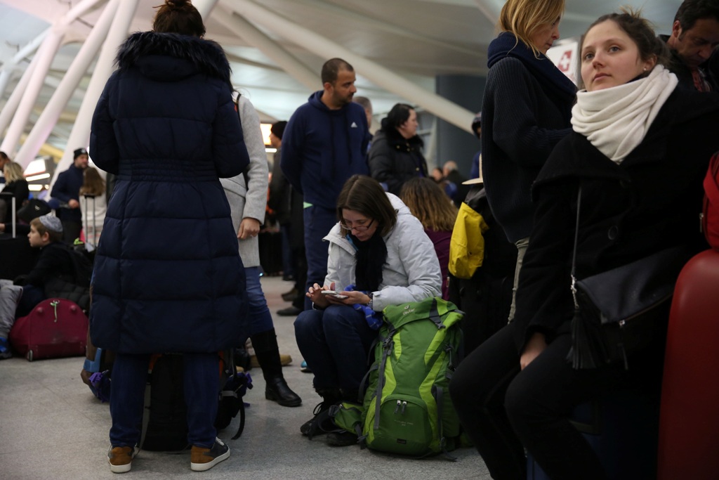 Passengers with their luggage are seen during the weather-related cancellation at the John F. Kennedy Airport in New York, United States on January 08, 2017. Mohammed Elshamy - Anadolu Agency