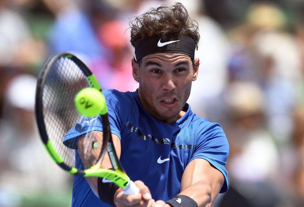 Rafael Nadal of Spain hits a backhand return against Richard Gasquet of France during the Kooyong Classic tennis tournament in Melbourne on January 9, 2018. AFP / WILLIAM WEST