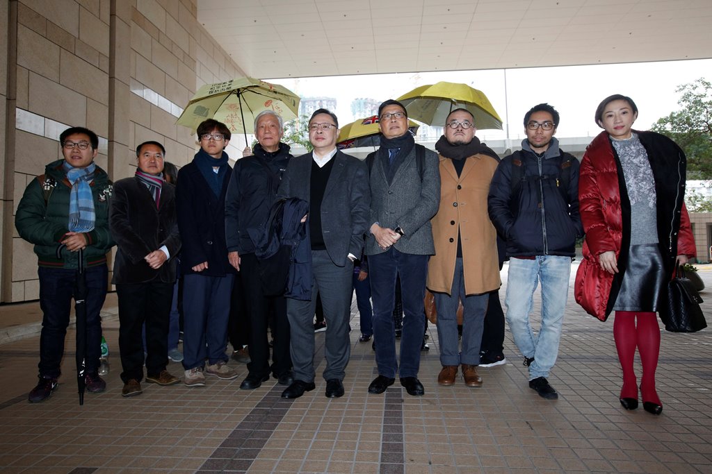 (L-R) Pro-democracy activists Raphael Wong, Lee Wing-tat, Cheung Sau-yin, Chu Yiu-ming, Benny Tai, Chan Kin-man, Shiu Ka-chun, Chung Yiu-wa and Tanya Chan pose outside a court after a pre-trial hearing in Hong Kong, China January 9, 2018. REUTERS/Bobby Yi