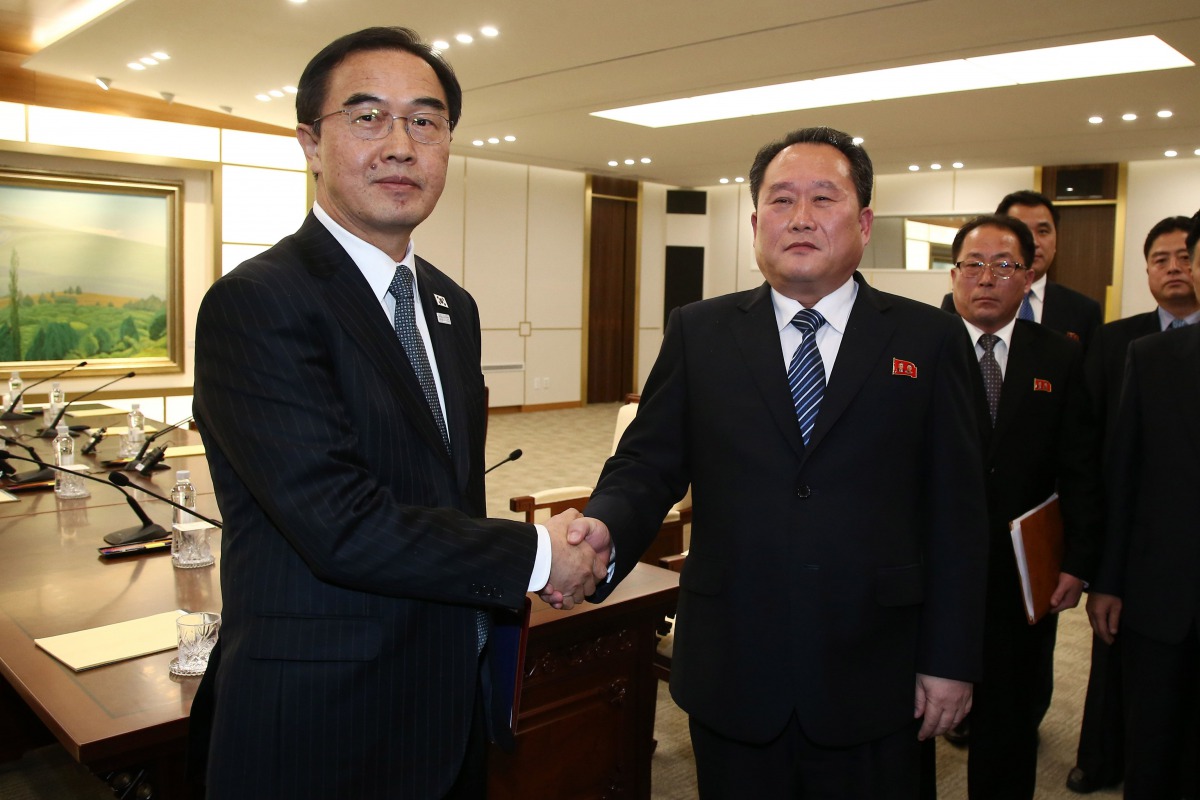 South Korea's Unification Minister Cho Myung-Gyun (L) shakes hands with North Korean chief delegate Ri Son-Gwon (2nd L) after their meeting at the border truce village of Panmunjom in the Demilitarized Zone (DMZ) dividing the two Koreas on January 9, 2018