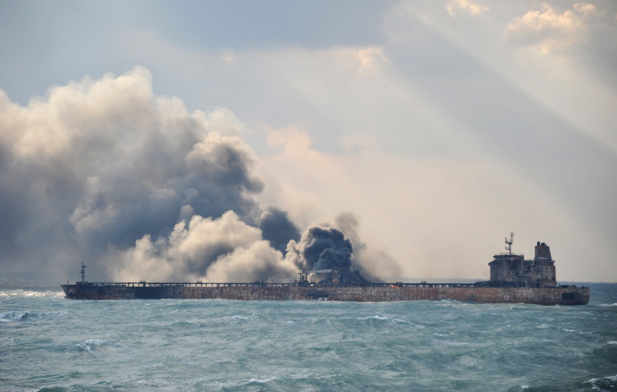 Smoke and flames coming from the burning oil tanker 