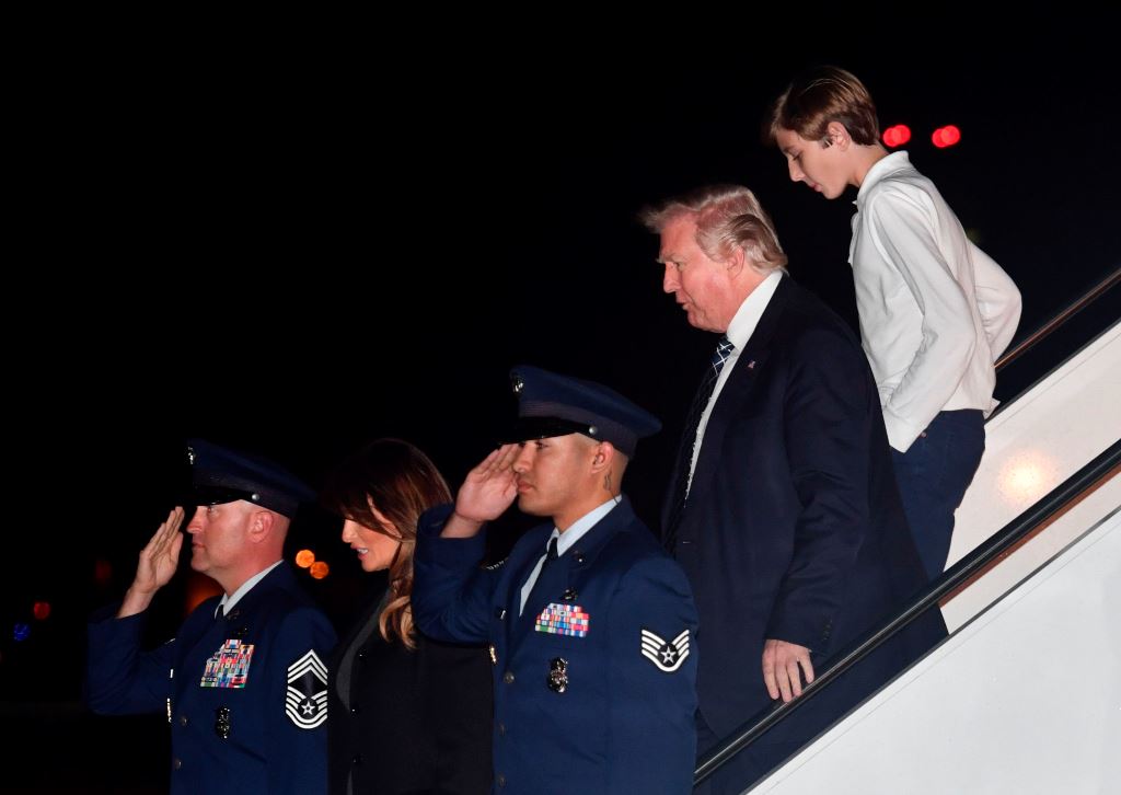 US President Donald Trump, son Barron and wife Melania step off Air Force One upon arrival at Palm Beach International Airport in West Palm Beach, Florida on January 12, 2018. AFP / Nicholas Kamm