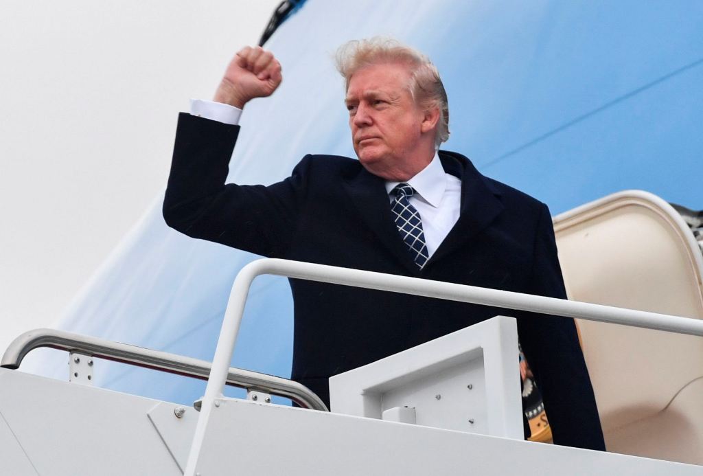 US President Donald Trump gestures as he boards Airforce One at Joint Base Andrews, Maryland on January 12, 2018, for a weekend trip to Mar-a-Lago. AFP / Nicholas Kamm