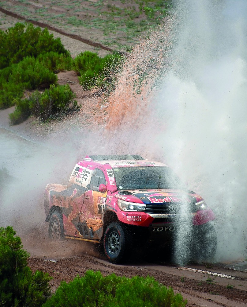 Nasser Al Attiyah of Qatar and co-pilot Matthieu Baumel of France drive their Toyota. They were leading yesterday’s longest stage.