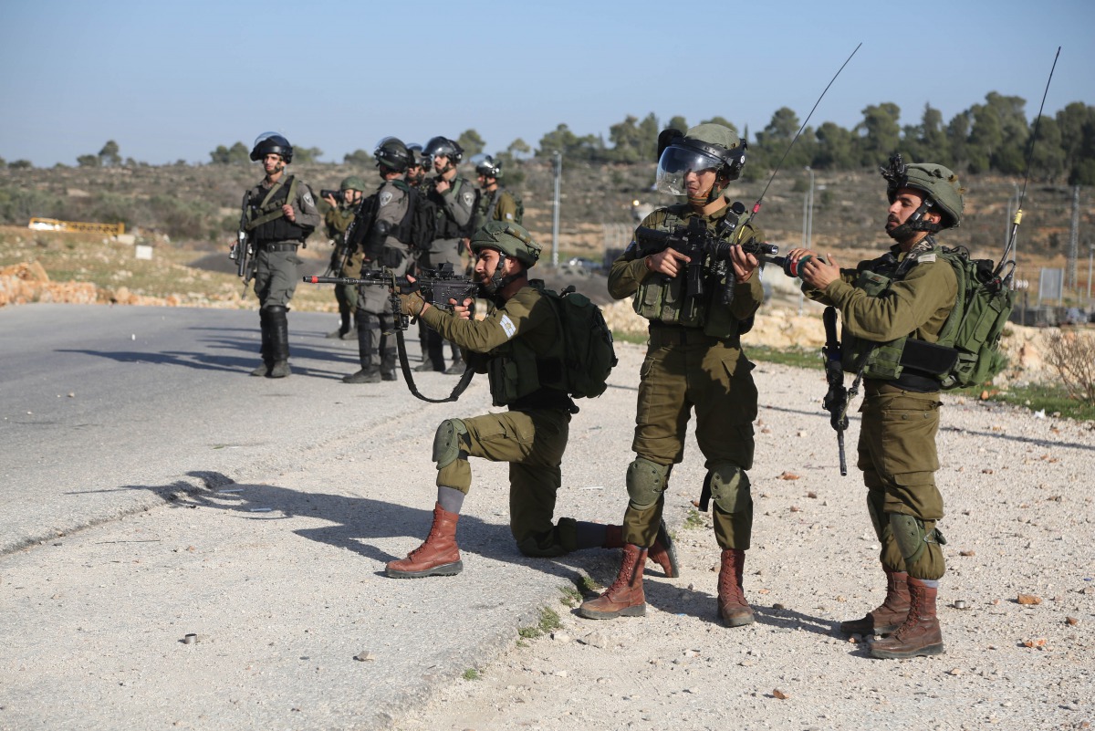 Israeli security forces intervene protestors during a demonstration to protest against U.S. decision to recognize Jerusalem as Israel's capital and to show their support for the Palestinian prisoners in Israeli jails, at Nebi Saleh village of Ramallah, We