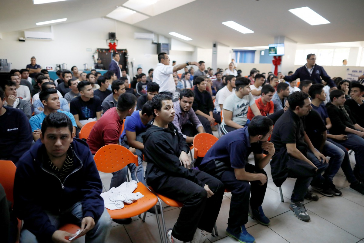 File photo: Deportees wait to be processed at an immigration facility after a flight carrying illegal immigrants from the US arrived in San Salvador, El Salvador, January 11, 2018. REUTERS/Jose Cabezas/File Photo