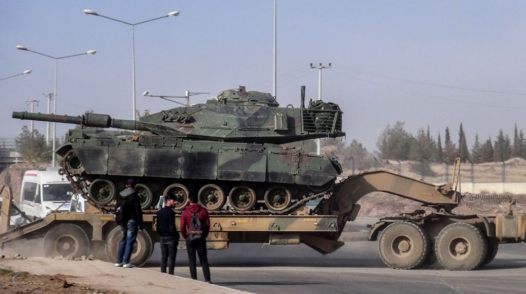A photo made available by the Dogan New Agency shows Turkish army military trucks transporting armoured vehicles to reinforce the border units in Sanliurfa close to the Syrian border on January 16, 2018. AFP / DHA
