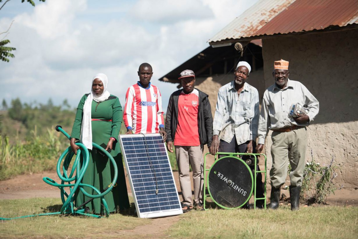 Ms.Madina Namutebi with her family ahead of work on their farm in Kyazanga, Uganda, on November 30, 2017. Handout: SolarNow / Lendahand Ethex