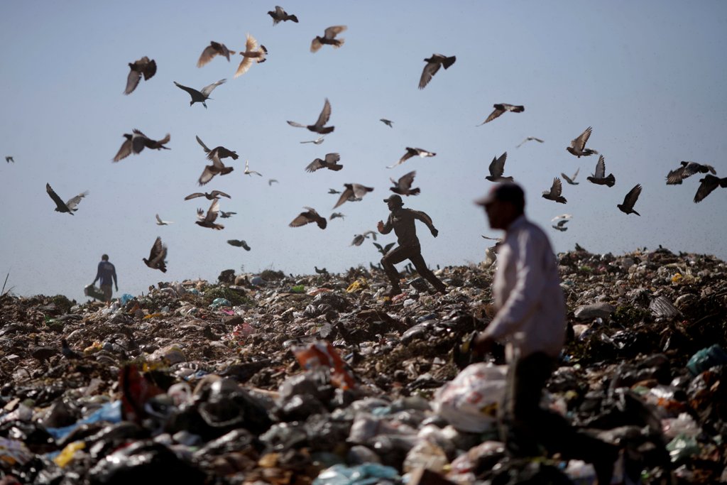 A man runs at 'Lixao da Estrutural', Latin America's largest rubbish dump, in Brasilia, Brazil, January 19, 2018. REUTERS/Ueslei Marcelino