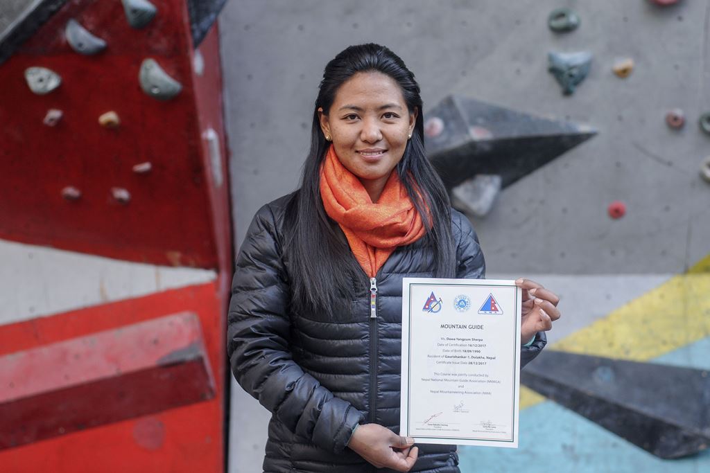 This photo taken on January 4, 2018, shows Nepali mountain guide Dawa Yangzum Sherpa posing with a mountaineering certificate in Kathmandu. AFP / Bikash Karki 