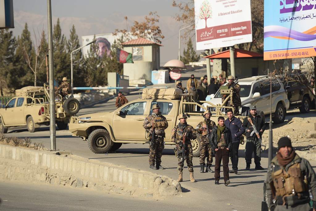 Afghan security personnel keep watch at the entrance of the Intercontinental Hotel during a fight between gunmen and Afghan security forces in Kabul on January 21, 2018. AFP / SHAH MARAI
