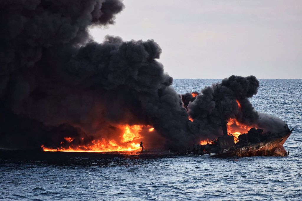 This handout file picture from the Transport Ministry of China taken and released on January 14, 2018 shows smoke and flames coming from the burning oil tanker 