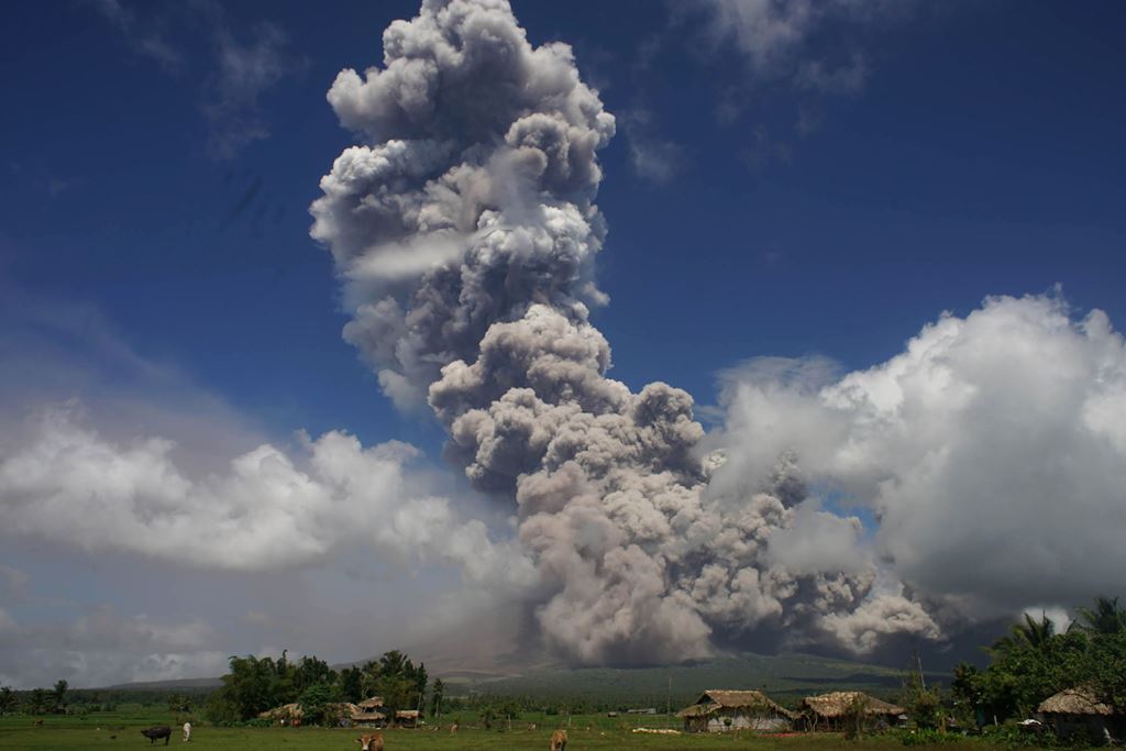 A giant mushroom-shaped cloud rises into the air from the Mayon volcano, seen from the highway in the town of Camalig, near Legazpi City in Albay province, south of Manila on January 22, 2018. AFP 