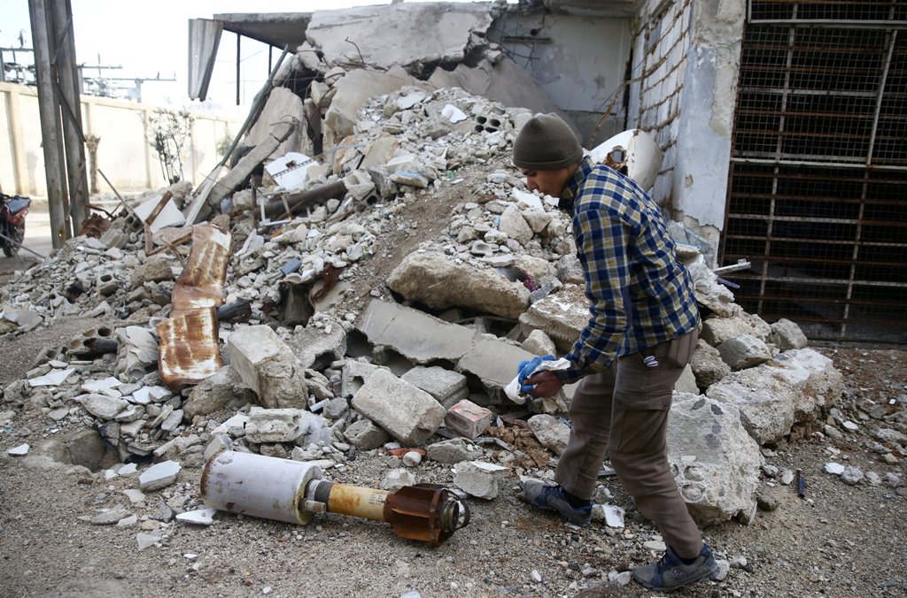 A man is seen near the remains of a rocket in Douma, Eastern Ghouta in Damascus, Syria January 22, 2018. REUTERS/Bassam Khabieh
