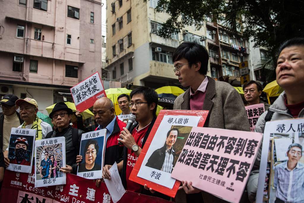 (FILES) This file picture taken on January 3, 2016 shows protesters holding up missing person notices of (L-R) Mighty Current publisher of books critical of China company's general manager Lui Bo and colleagues Cheung Jiping, Gui Minhai, Lee Bo and Lam Wi