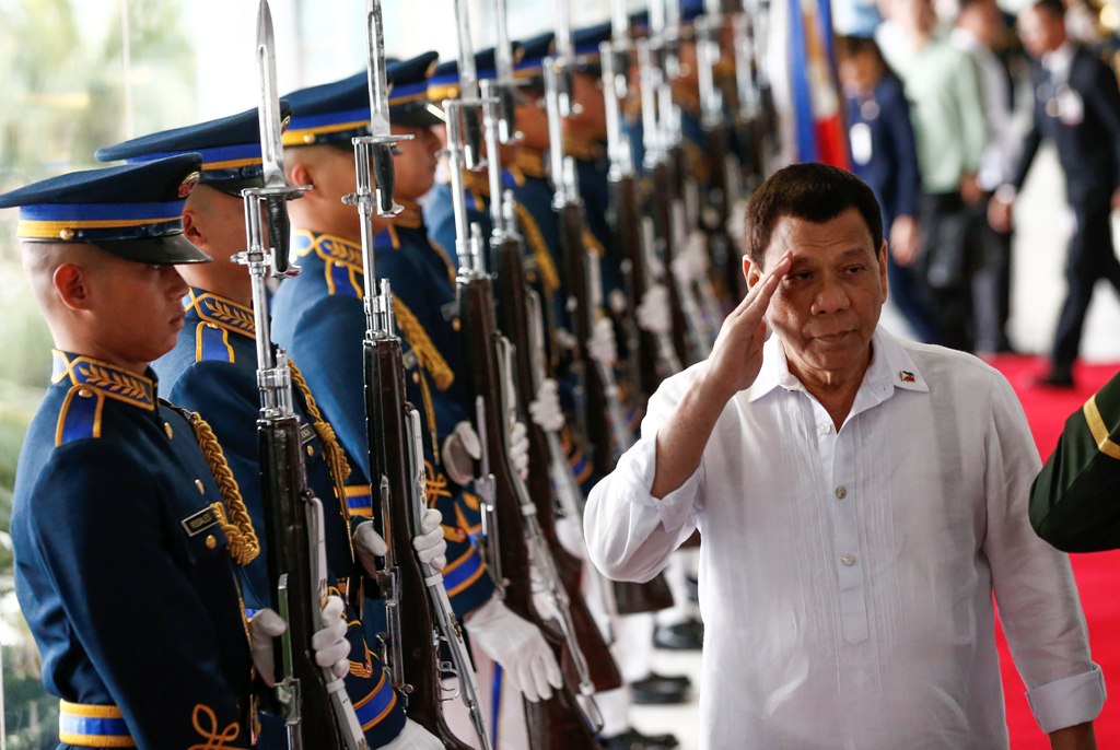 Philippine President Rodrigo Duterte (R) salutes military honor guards during departure rites from the Ninoy Aquino International Airport in Manila, Philippines, 24 January 2018. EPA/ROLEX DELA PENA