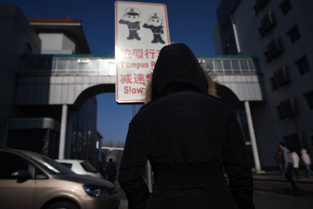 This picture taken on January 17, 2018, shows a woman walking at Beihang University in Beijing. AFP / Wang Zhao 