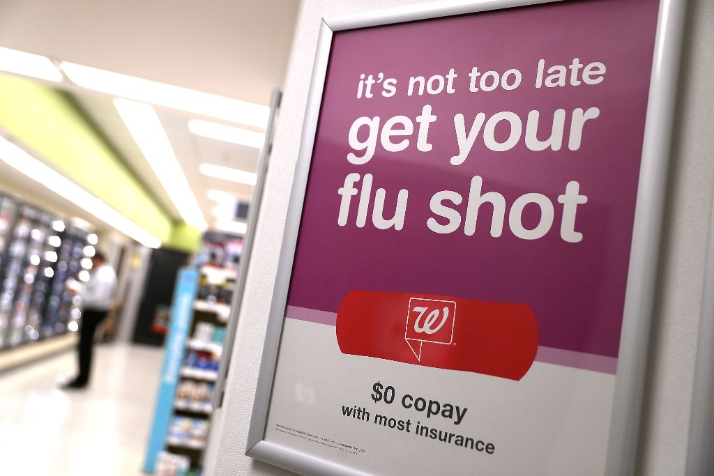 File photo of a sign advertising flu shots is displayed at a Walgreens phramacy in San Francisco, California, January 22, 2018.  / AFP / GETTY IMAGES NORTH AMERICA / JUSTIN SULLIVAN
