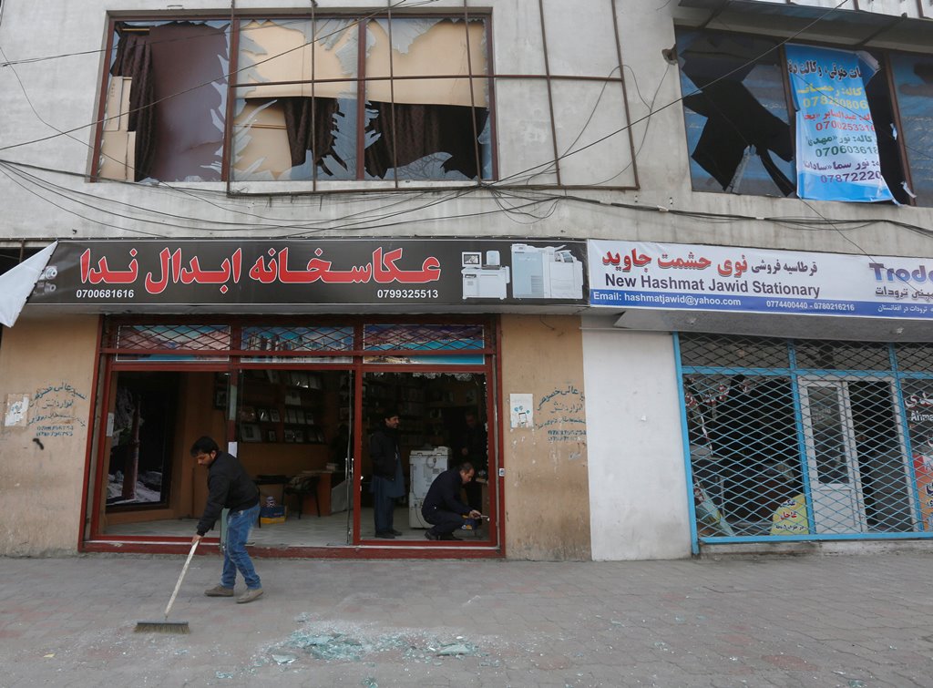 An Afghan shopkeeper sweeps glass from broken windows near the site of a bomb attack in Kabul, Afghanistan, January 28, 2018. Reuters/Omar Sobhani	
