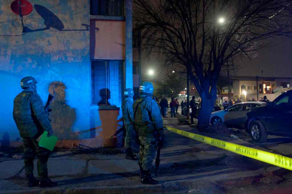 Members of the Mexican army patrol the area where seven people were killed inside a house, while they were watching a soccer game in Monterrey, Mexico on January 28, 2018.  AFP / Julio Cesar AGUILAR
