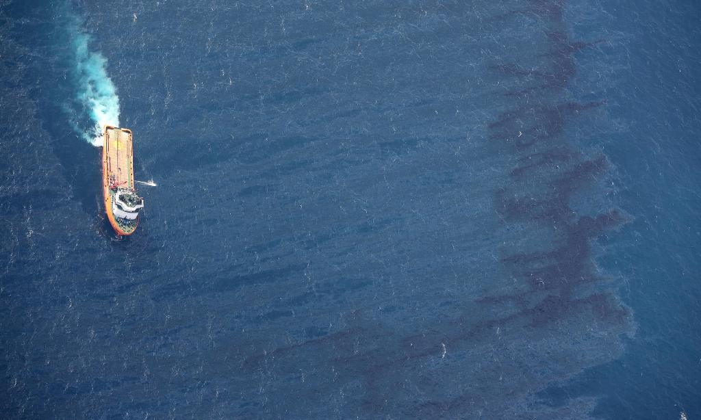 China’s offshore supply ship De Shen working at an oil spill area during a clean-up operation at sea off the coast of eastern China. Transport Ministry Of China