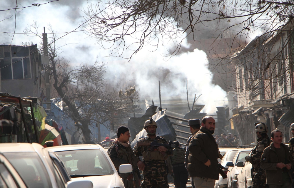 Afghan security officials inspect the blast site in Kabul, Afghanistan on January 27, 2018. Haroon Sabawoon - Anadolu 