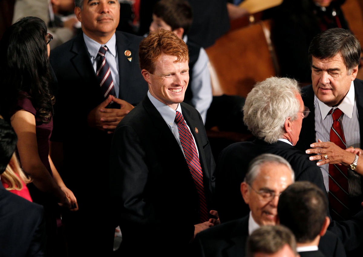 Newly elected Massachusetts Democratic Representative Joseph Kennedy III (C) smiles as he joins the 113th Congress in the Capitol in Washington January 3, 2013.  REUTERS/Kevin Lamarque