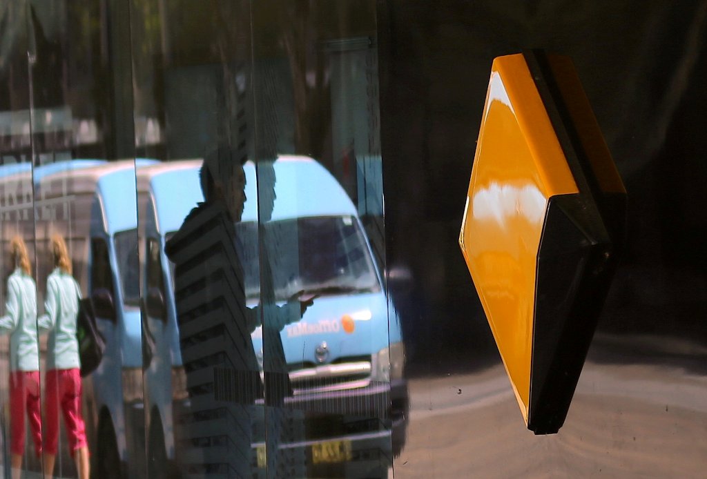 File photo of pedestrians are reflected in the window of a branch of the Commonwealth Bank of Australia (CBA), Australia's biggest bank by market value, in Sydney, Australia, November 8, 2017. REUTERS/Steven Saphore/File Photo 