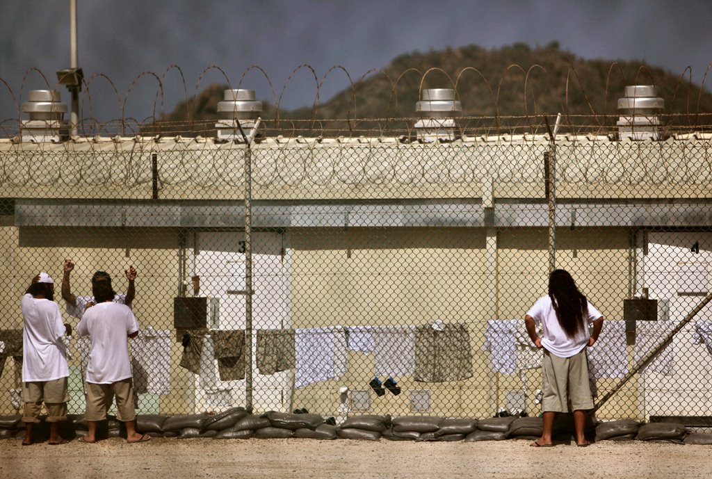 FILE PHOTO: Detainees talk together inside the open-air yard at the Camp 4 detention facility at Guantanamo Bay U.S. Naval Base in Cuba, May 31, 2009. REUTERS/Brennan Linsley/Pool/File Photo	
