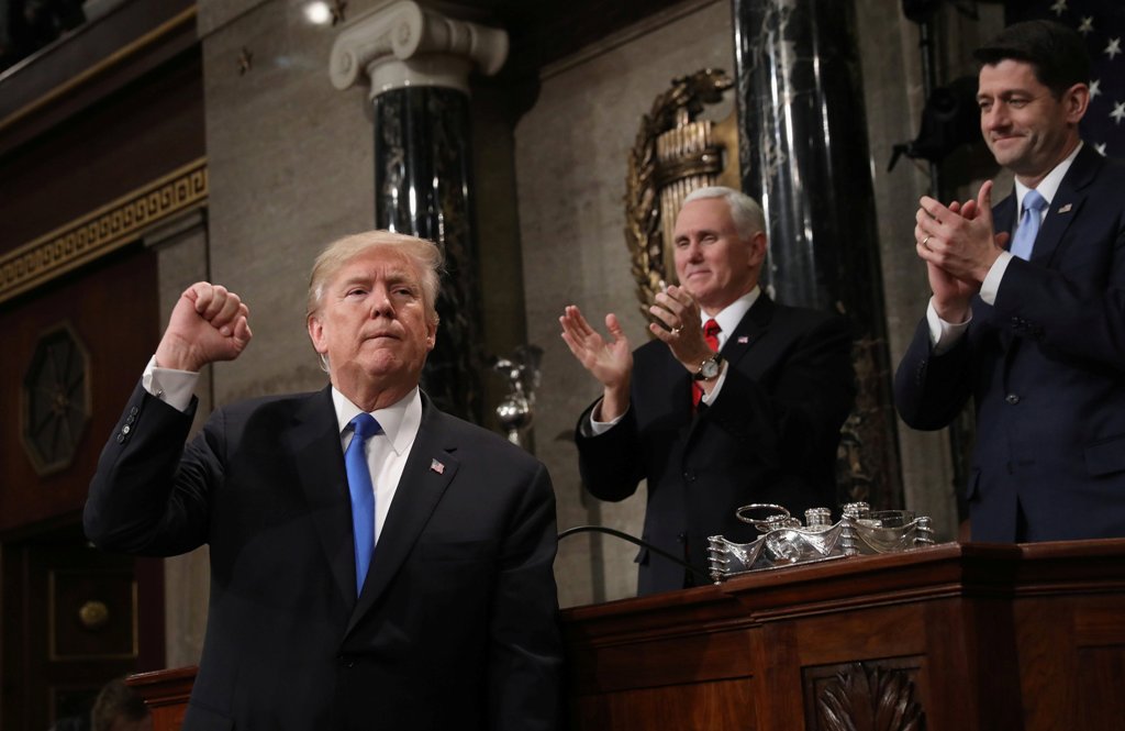 US President Donald J. Trump (L) gestures at the podium in front of US Vice President Mike Pence (L) and Speaker of the House US Rep. Paul Ryan (R-WI) during his first State of the Union address to a joint session of Congress inside the House Chamber on C