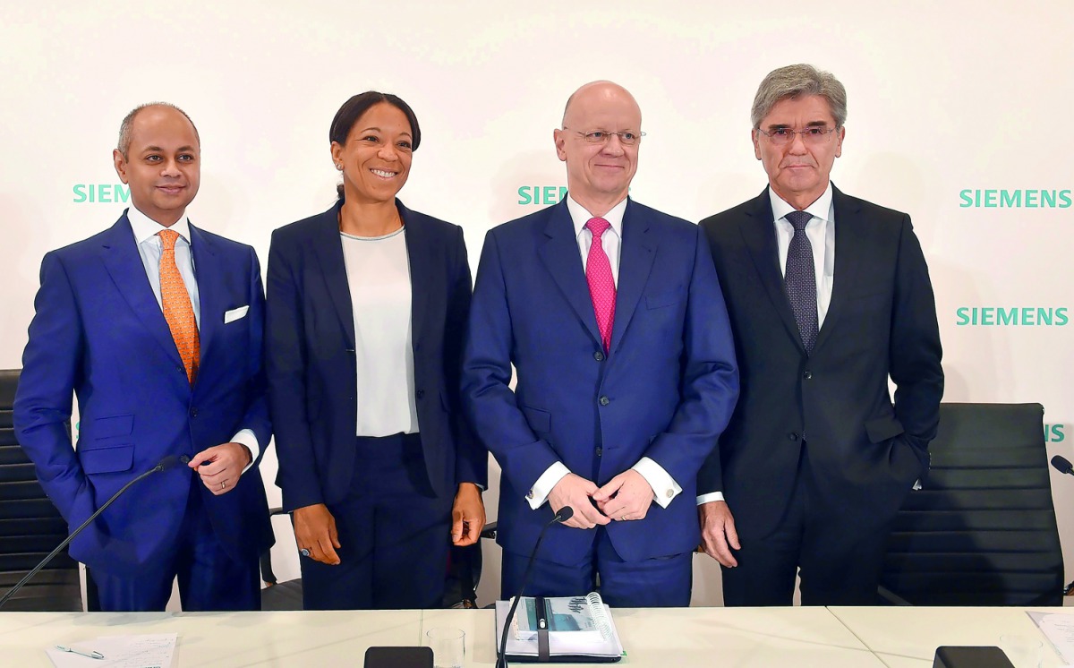 (L-R) Michael Sen, member of the board, Janina Kugel, Chief Human Resources Officer, Ralf P Thomas, CFO, and Joe Kaeser, CFO, pose during a press conference of the German industrial giant Siemens, ahead of the annual shareholder's meeting at the Olympic h