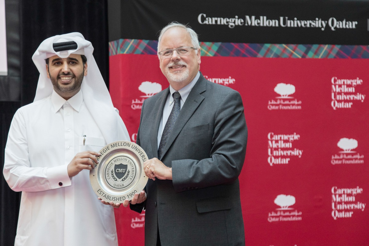 Michael Trick, dean of CMU-Q  presents a memento to  Abdulaziz Bin Nasser Al-Khalifa  