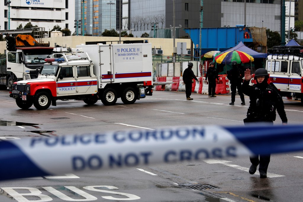 Members of the police bomb squad cordon off an area where a World War Two bomb was found at a construction site in Hong Kong, China January 31, 2018. REUTERS/Bobby Yip
