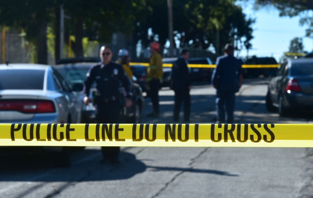 Police guard a roadblock to Salvadore Castro Middle School in Los Angeles, California on February 1, 2018, where two students were wounded, one critically, in a school shooting. / AFP / Frederic J. Brown